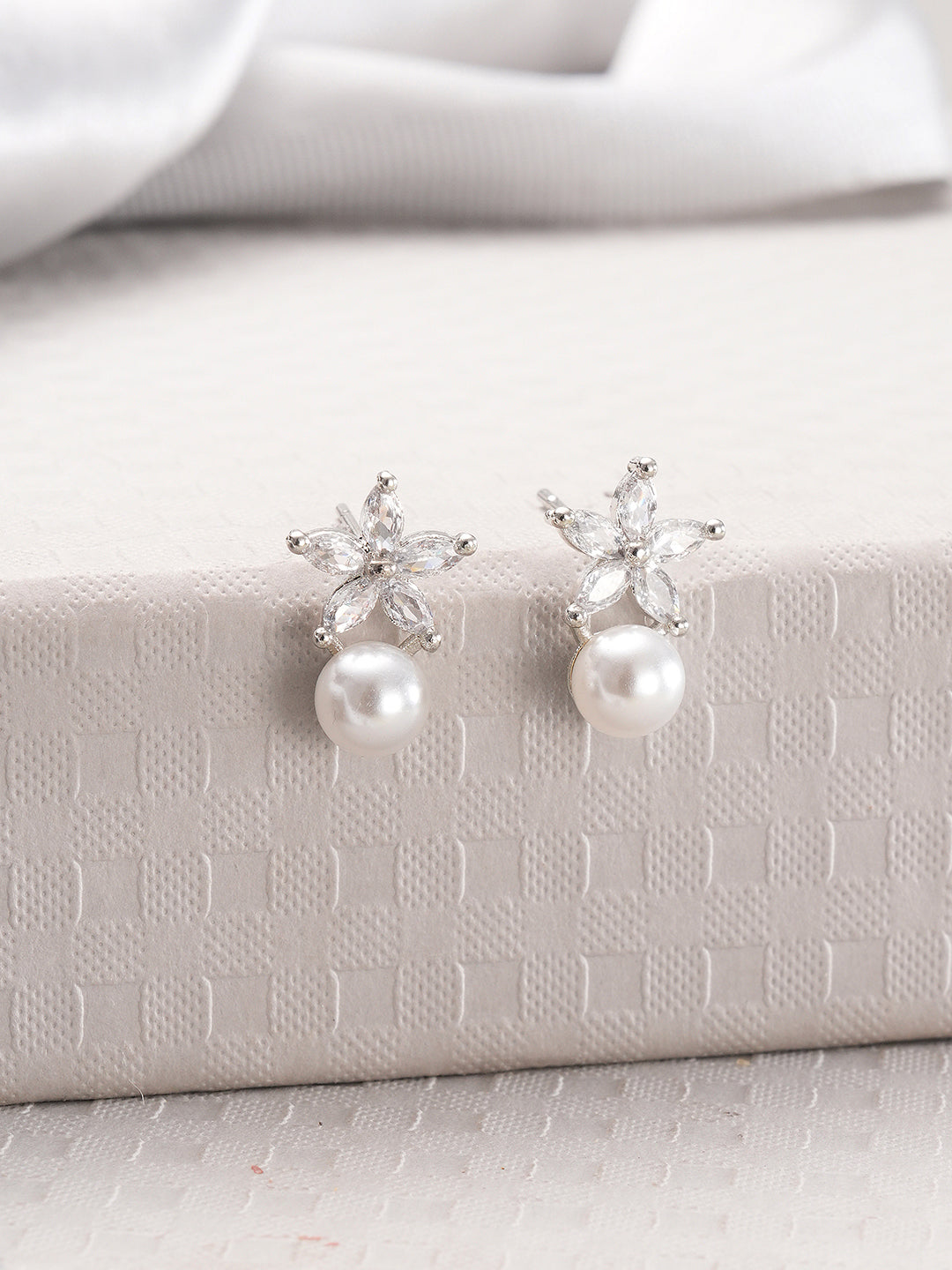 Jazz And Sizzle Rhodium Plated Floral Shaped Pearl Studded Drop Earrings