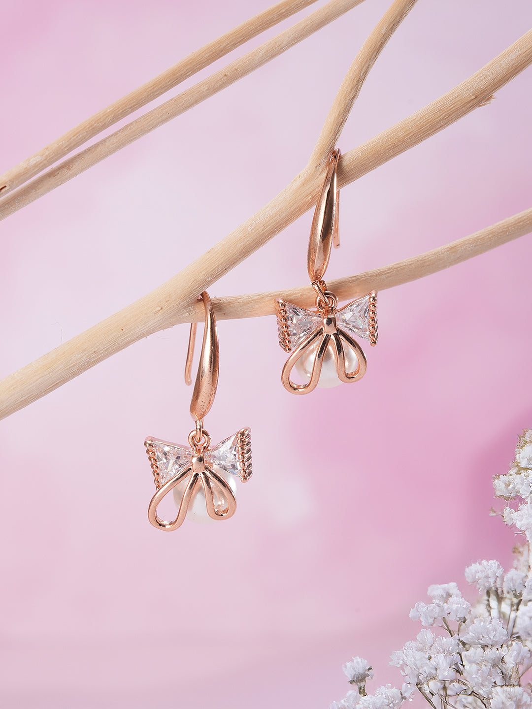 Jazz And Sizzle Rose Gold-Plated Bow Shaped Pearl Studded Drop Earrings