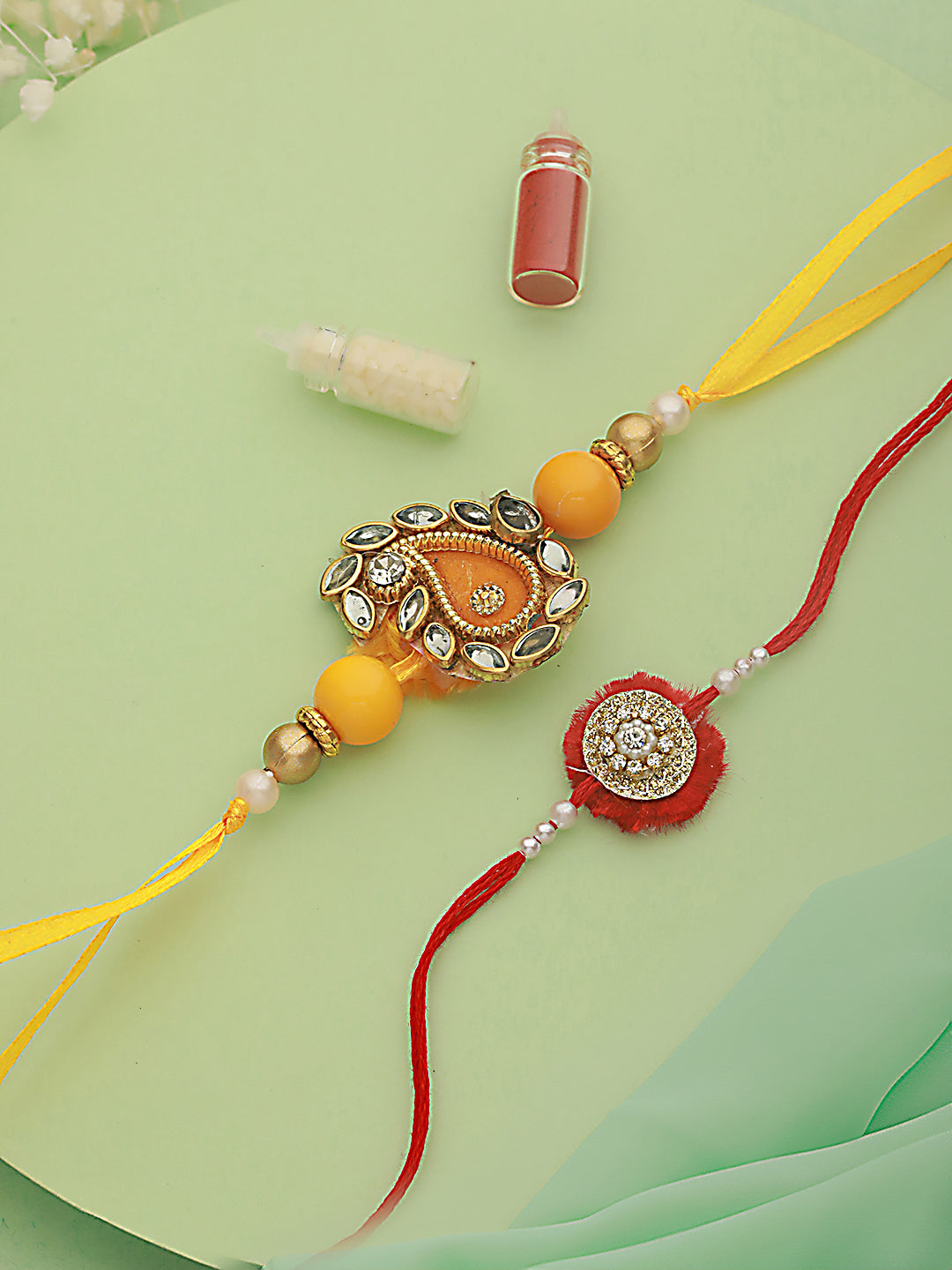 Jazz And Sizzle Unisex Set Of 2 Red & Yellow Leaf Shaped Rakhi With Roli & Chawal