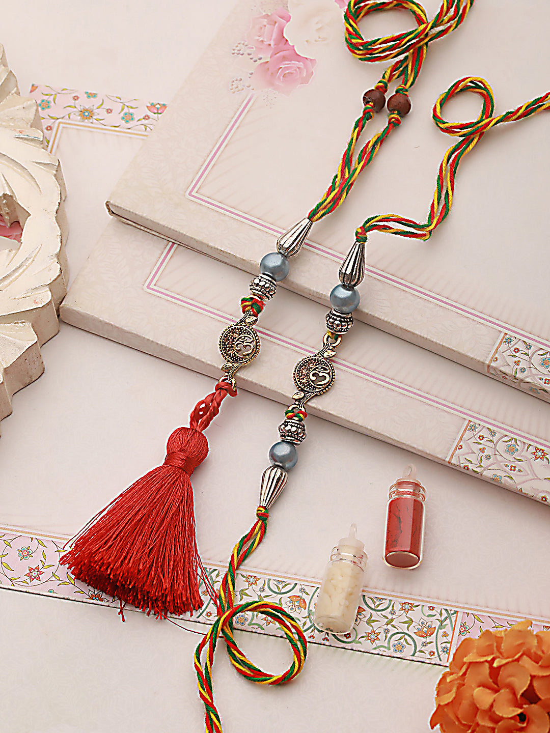 Jazz And Sizzle Set Of 2 Om & Pearl Beaded Bhaiya Bhabhi Tasseled Rakhi