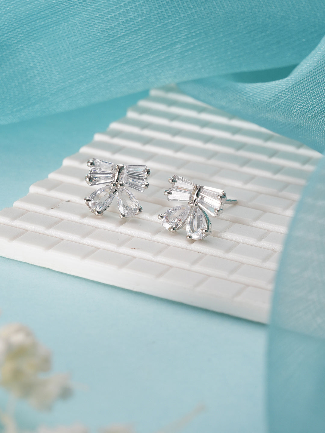 Jazz And Sizzle Silver Plated American Diamond Studded Bow Shaped Contemporary Studs