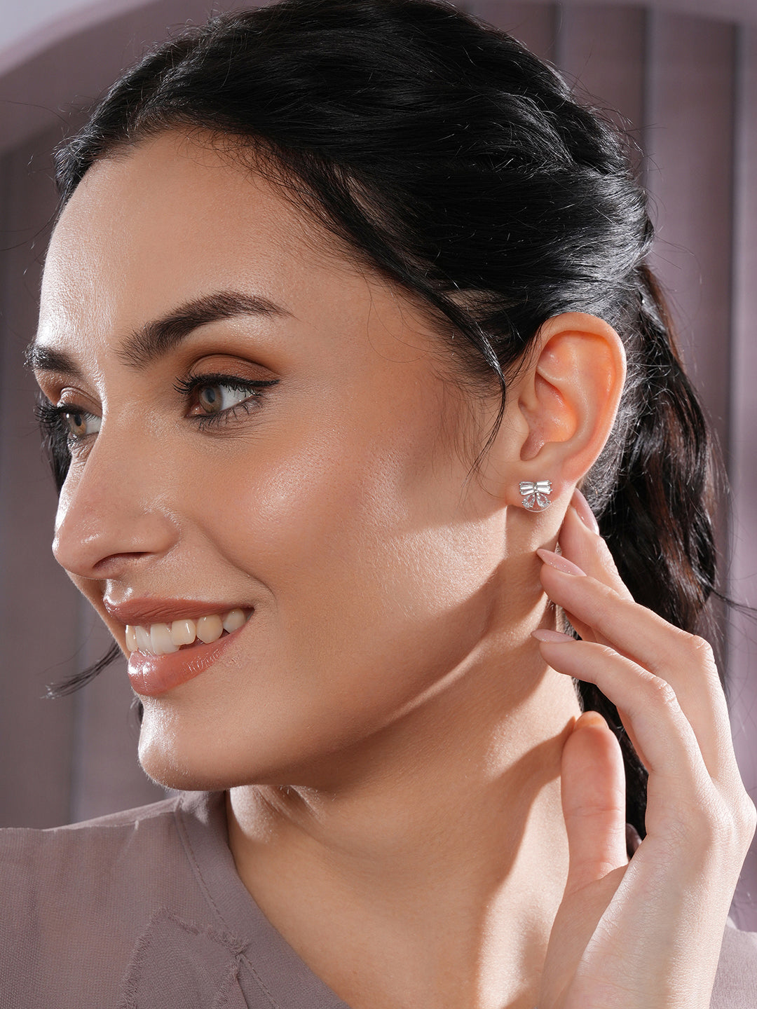 Jazz And Sizzle Silver Plated American Diamond Studded Bow Shaped Contemporary Studs