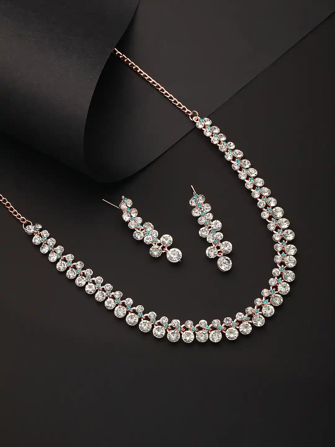 Jewelry set with necklace and earrings on a black background