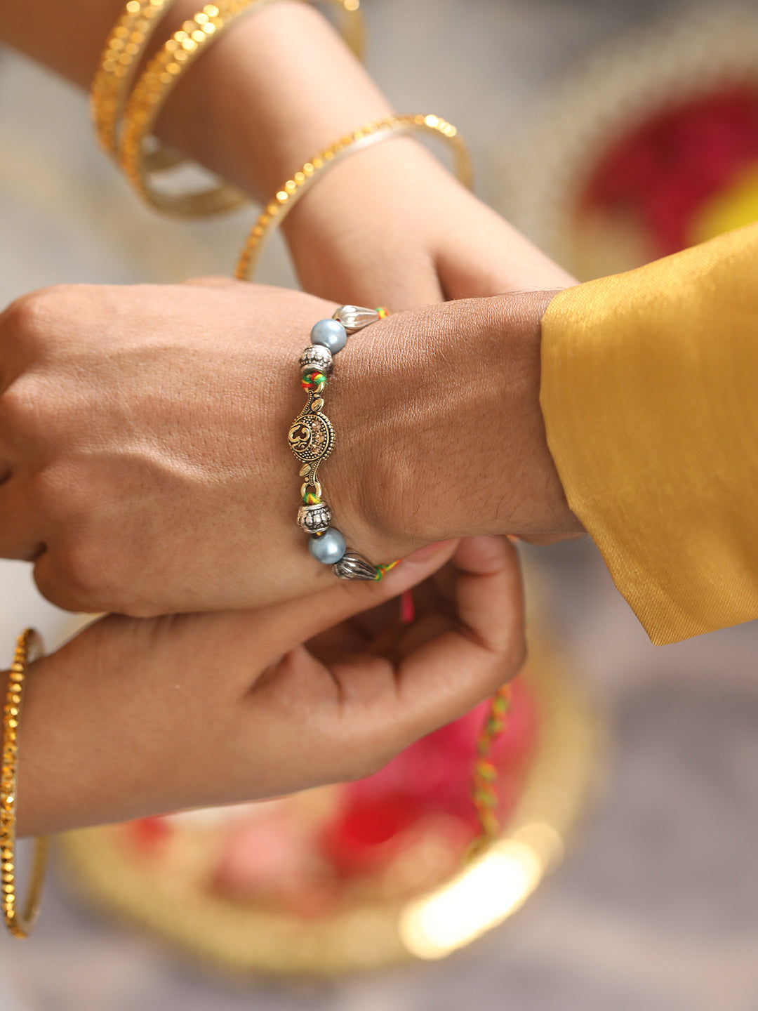 Set Of 2 Om & Pearl Beaded Bhaiya Bhabhi Tasseled Rakhi With Roli & Chawal