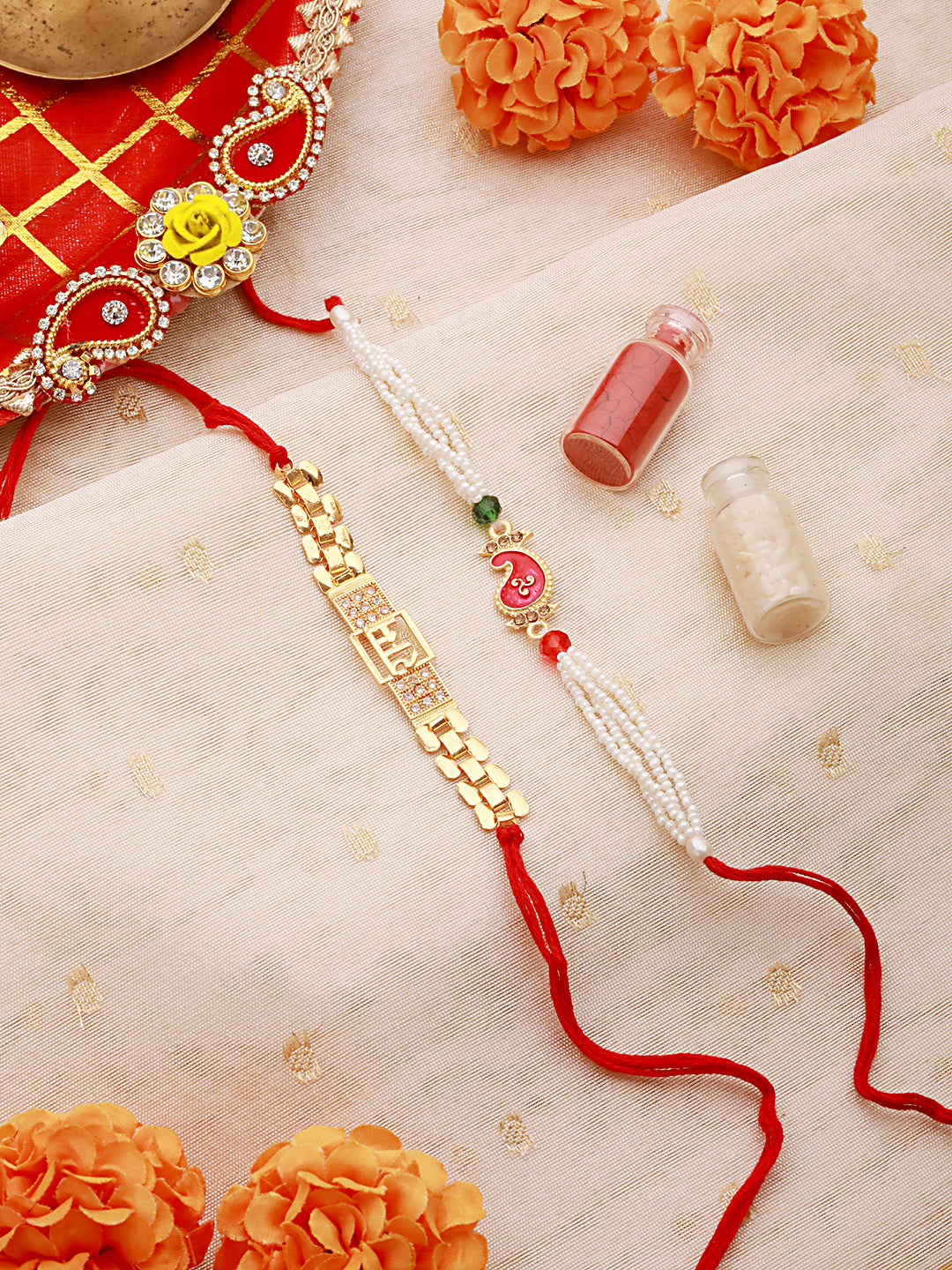 Set Of 2 Gold Toned Ram & Leaf Shaped Pearl Beaded Rakhi With Roli & Chawal