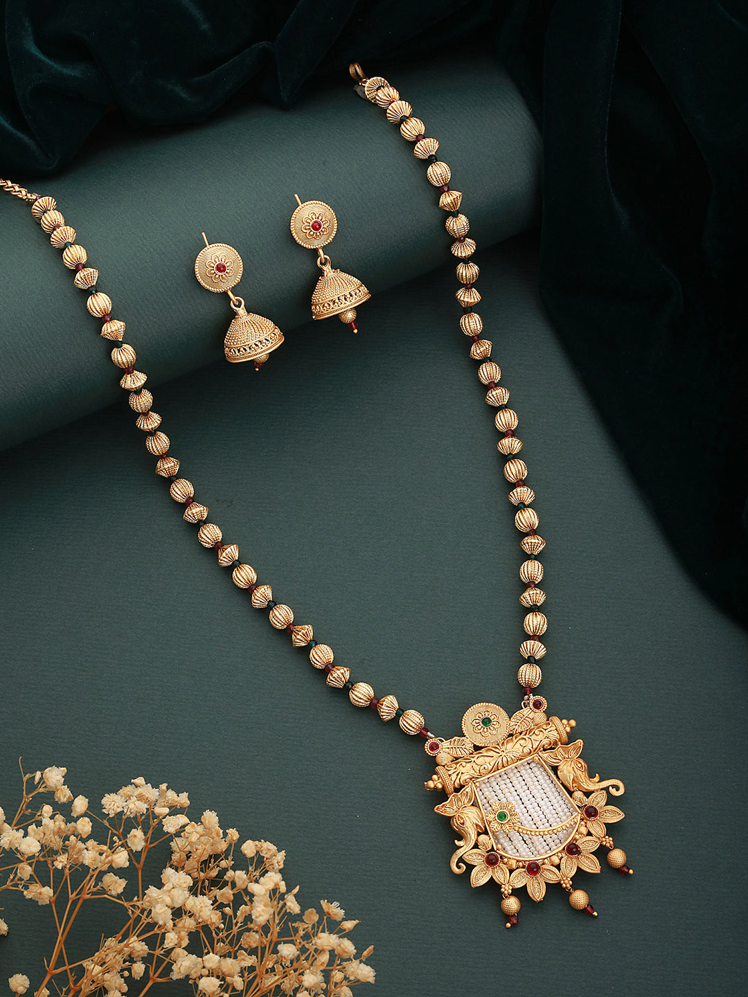 Designer gold necklace blending modern and traditional aesthetics.